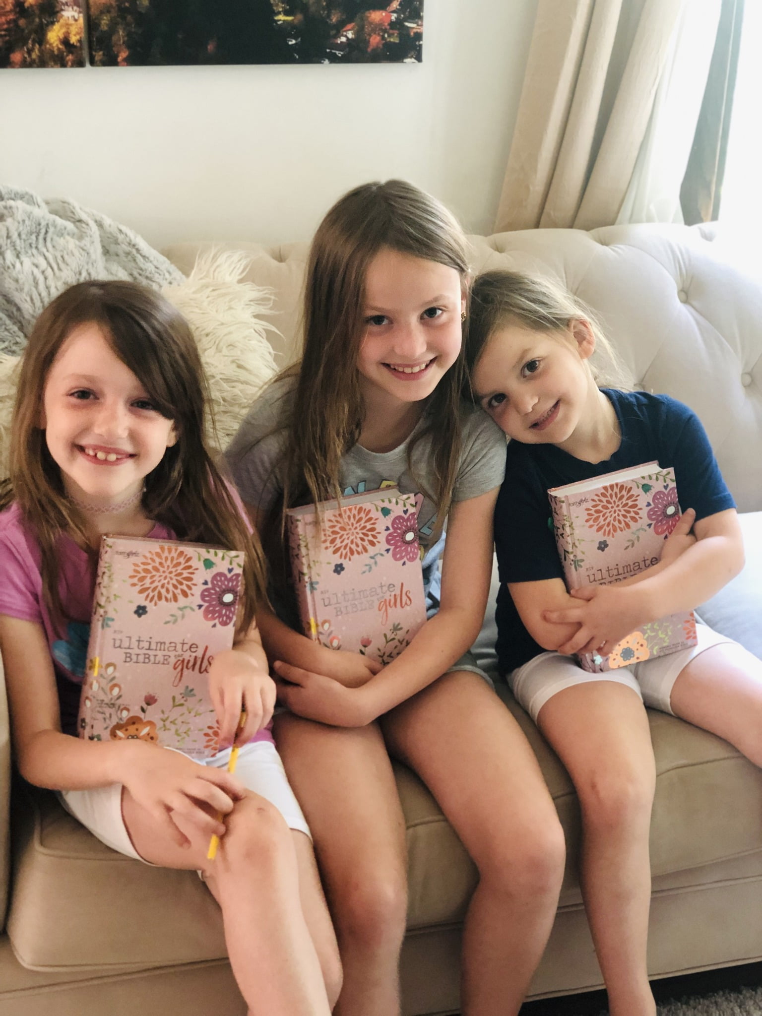 The Cross girls enjoy their new Bibles with their father, JC Cross, in their home in Minnesota.