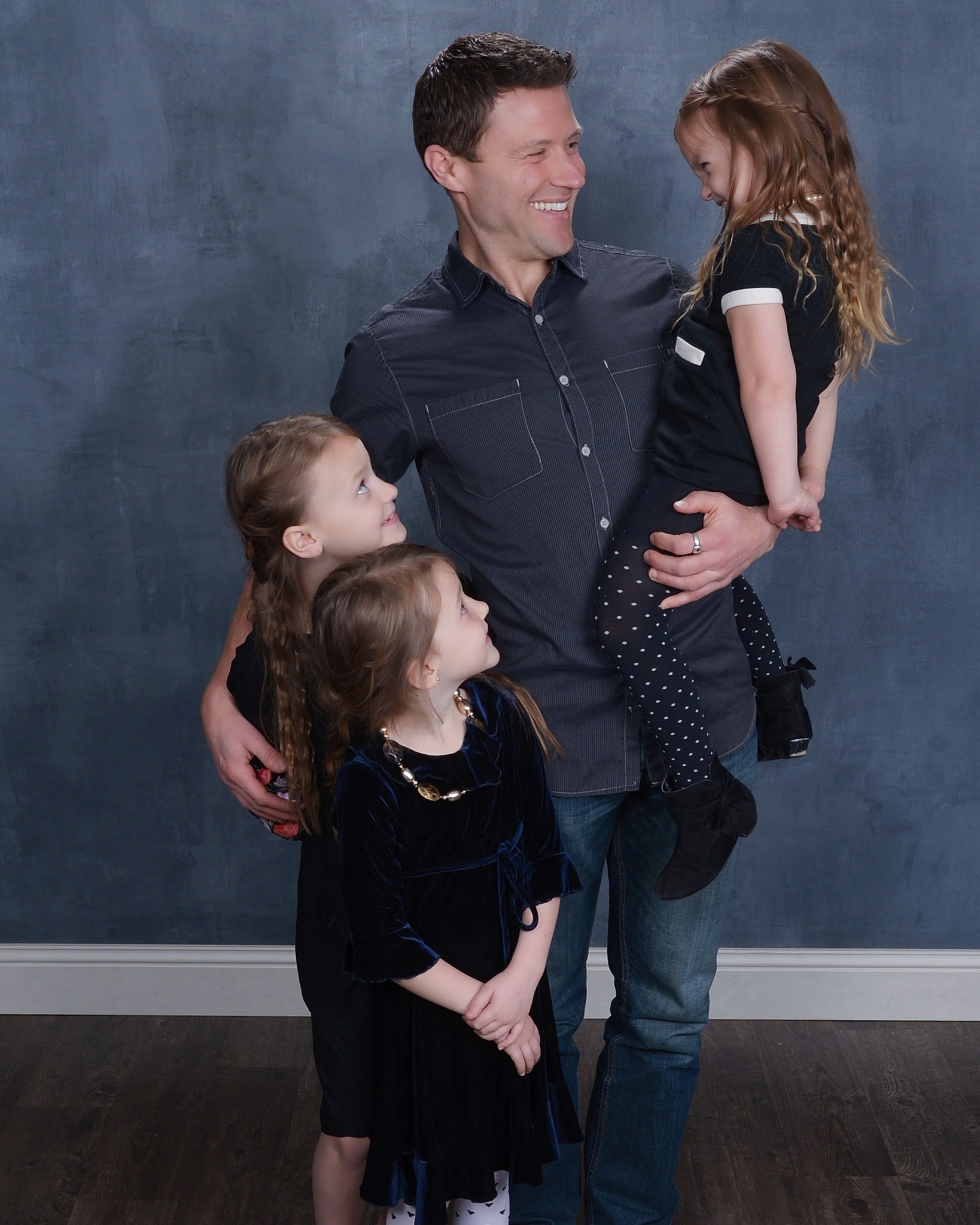 JC Cross with his three daughters laughing