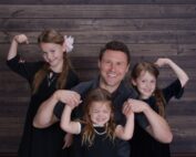 JC Cross with his three daughters flexing